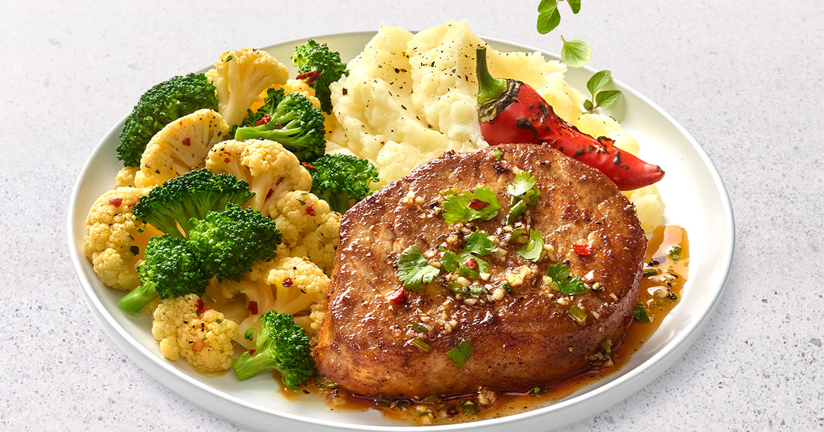 Plate of pork loin with mashed potatoes & broccoli medley